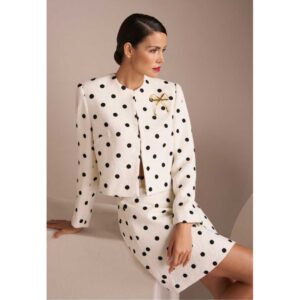 Woman in classic black and white polka dot suit