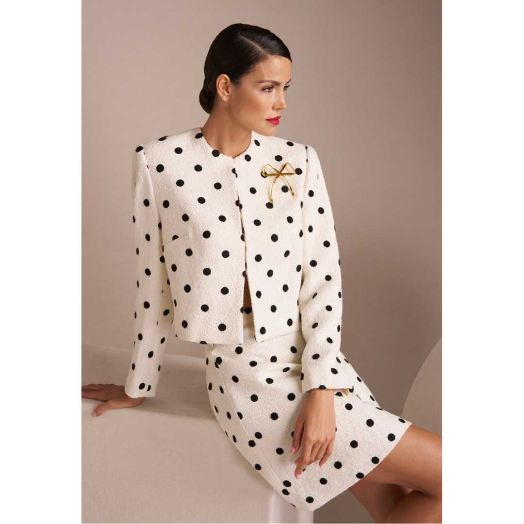 Woman in classic black and white polka dot suit