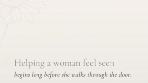 Helping women feel seen on a beige background with a subtle wildflower embossed on the edge.